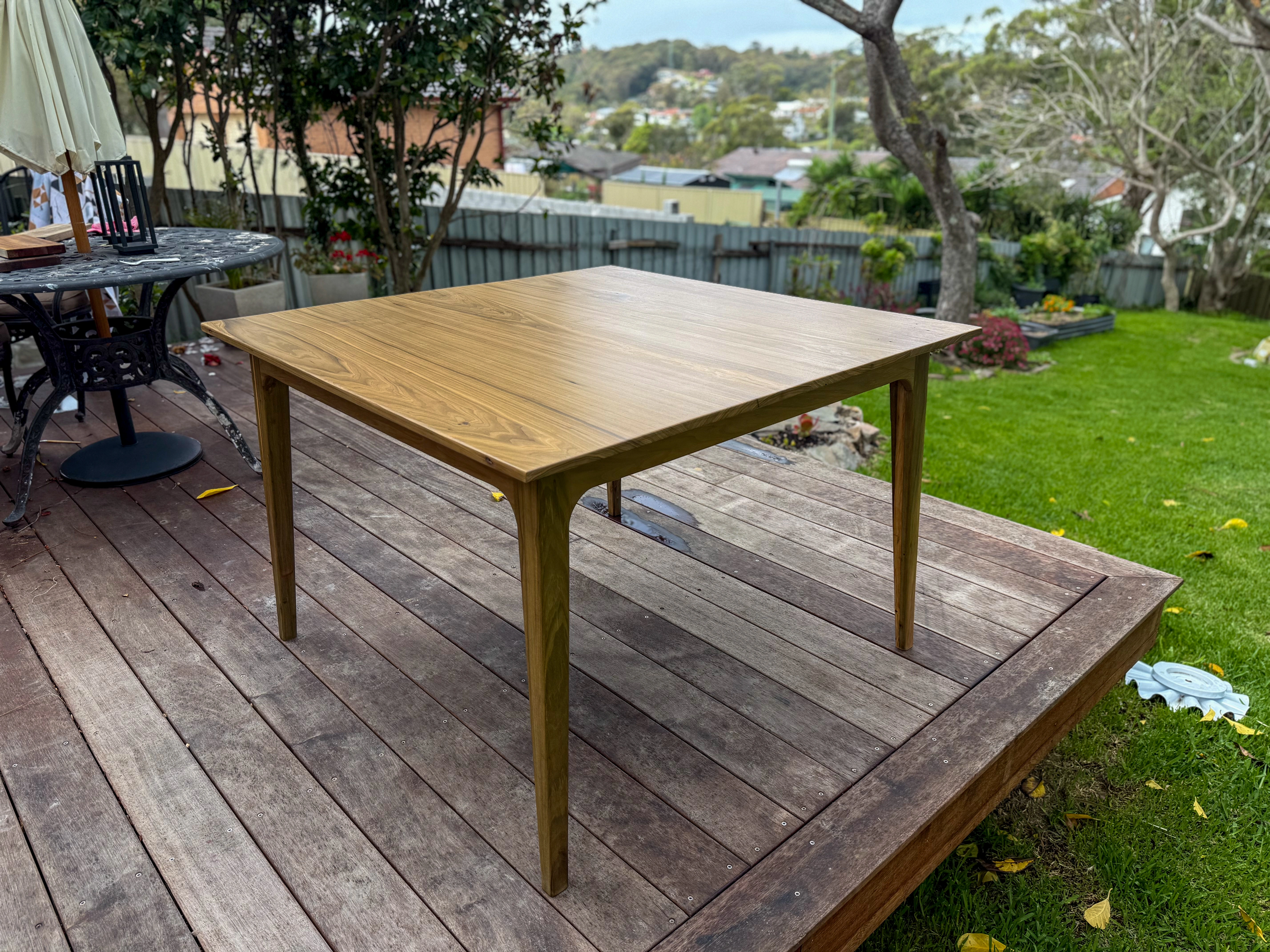 Finished teak dining table