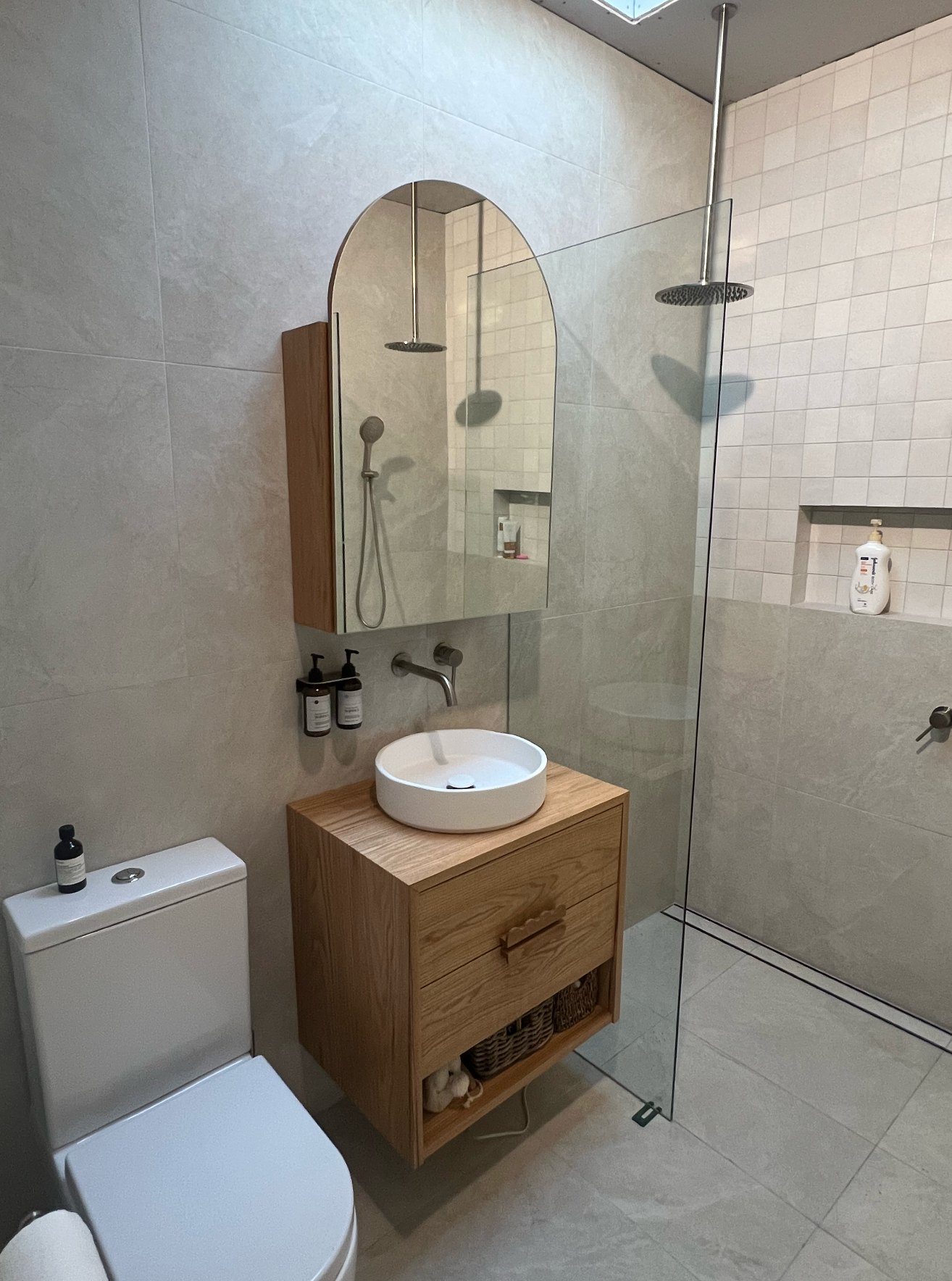 Solid timber bathroom vanity and shaver cabinet in a tiled bathroom